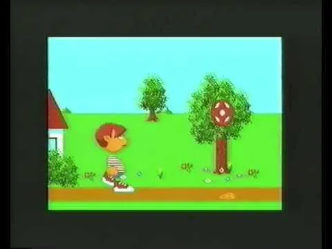 Still from the Atari animation: a pixelated boy with red hair and a striped shirt next to a house, with a ball stuck in a tree on a bright green lawn.