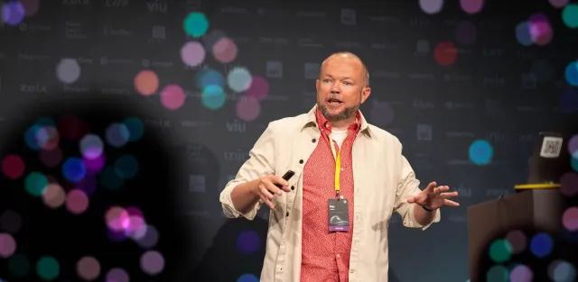 Per Axbom on stage at Front Conference, gesturing with a clicker in his hand.